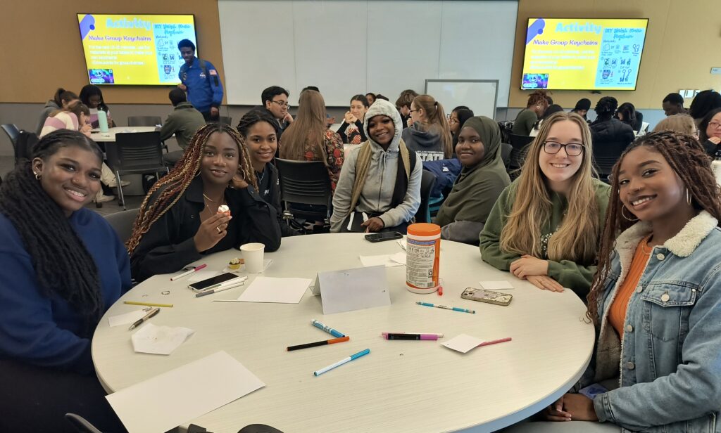 A group of students sitting around a round table.